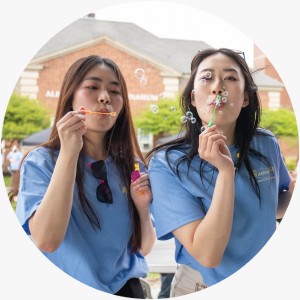 Two students blow bubbles at ACPHS Springfest