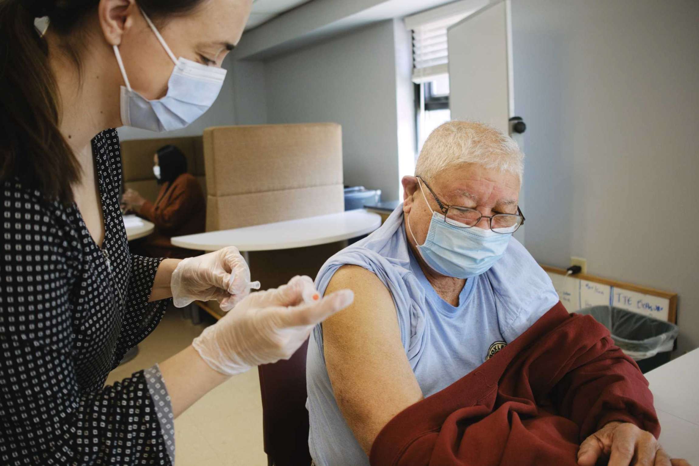 Pharmacist vaccinating patient