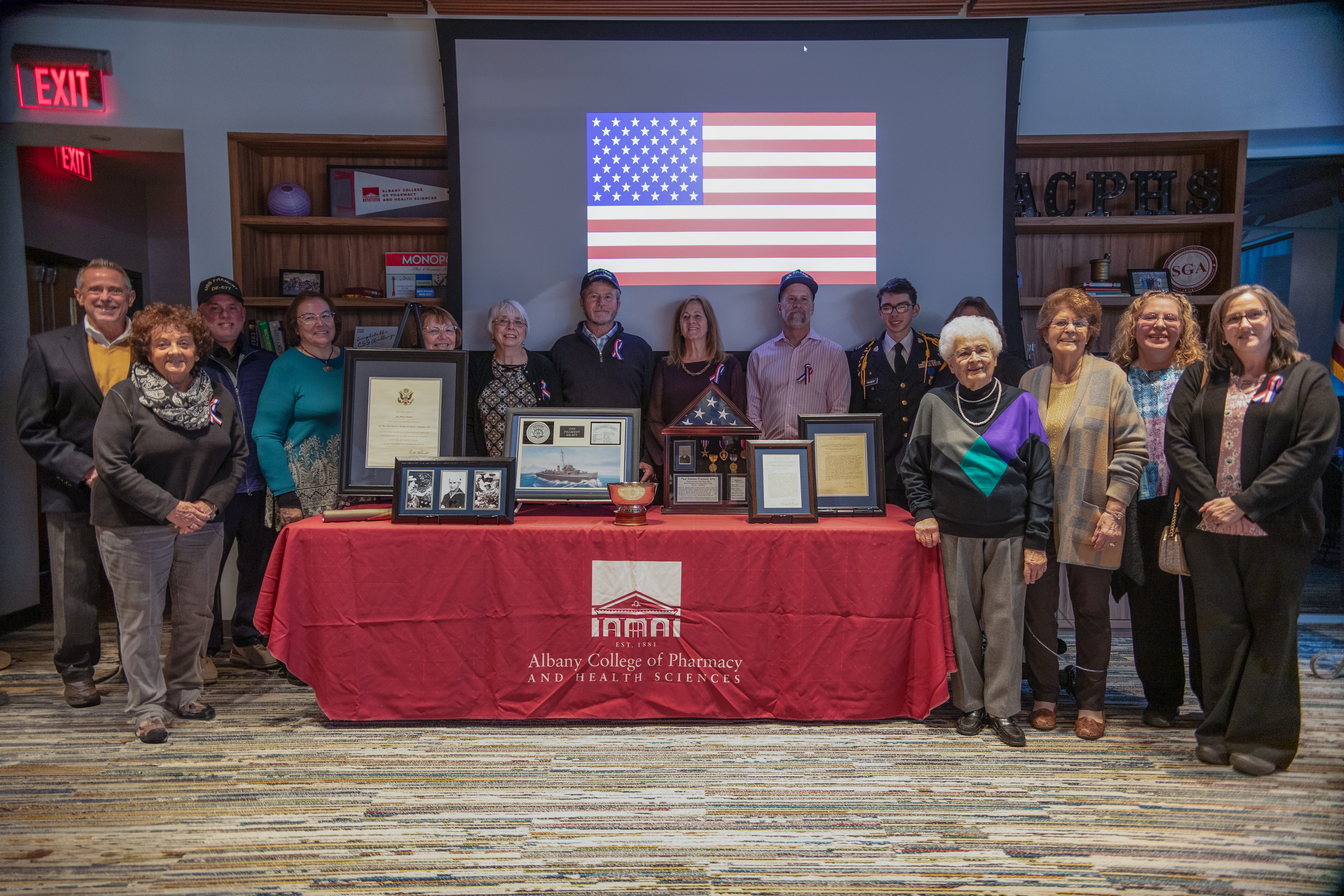 Relatives of Paul Stanley Frament '39 gathered around the artifacts they donated to the College.