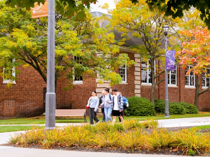 Students walk on campus on a beautiful fall day