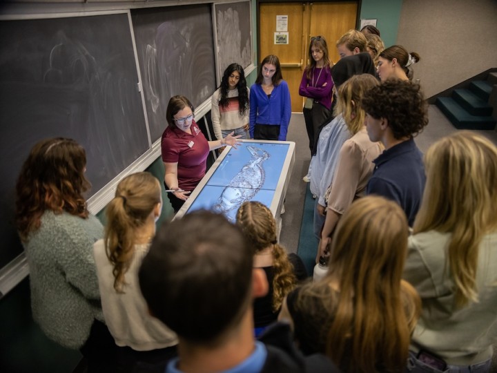 Dr. Shakerley stands with students at Anatomage Table