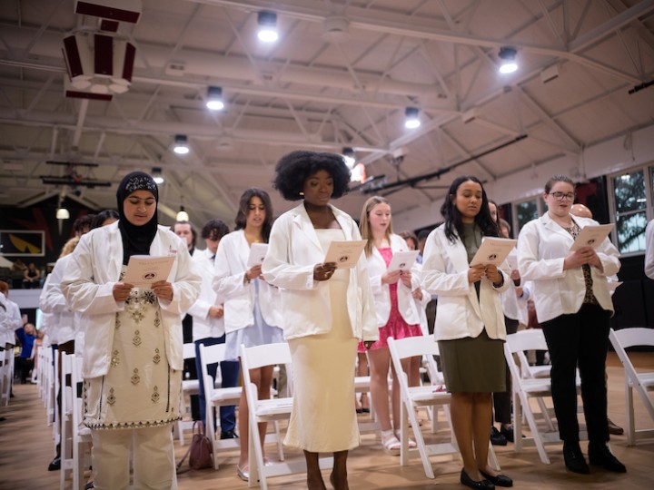 Students take an oath of a pharmacist during white coat ceremony