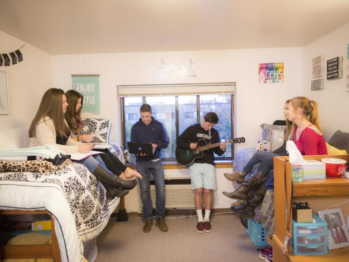 students hanging out in dorm room