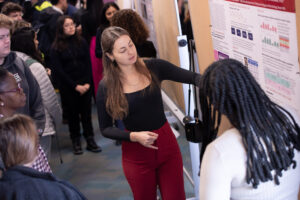 Student presents poster at research symposium
