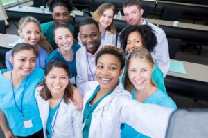 A group of medical students stand in their classroom
