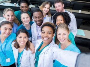 Group of medical students take selfie in classroom