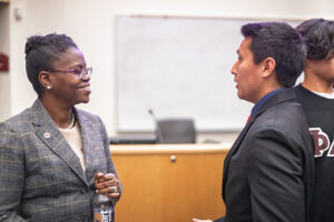 ACPHS President Toyin Tofade speaks with Phi Delta Chi member Alexander Campos at a leadership event.