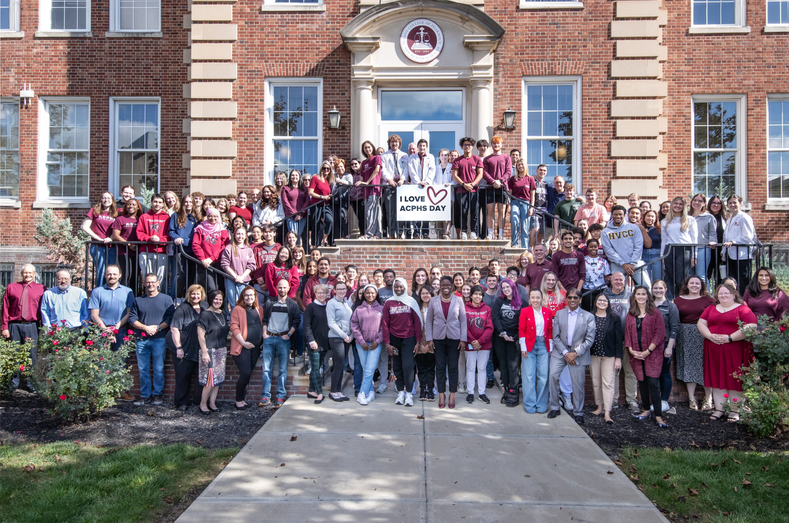 ACPHS campus stand on library steps for I Love ACPHS Day