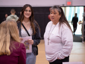 Admissions staff speaks with prospective student and parent
