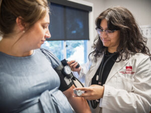 Anjali Kota takes blood pressure of patient during rotation