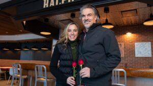 Art & Kim Broga hold a rose