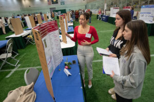 Diandre Slusarek discusses her research at Regeneron STEM Poster Showcase on April 19, 2024