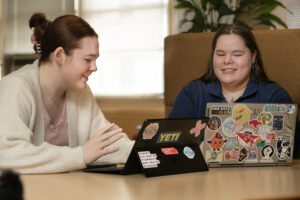 Students Justine Wright and Audrey DeGraw discuss promotional materials for an April 9, 2025 blood drive