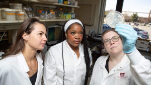 Diandre Slusarek and Aysha Mills with Dr. Anne McCabe in lab