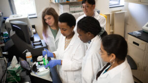 Dr. Kideok with pharmaceutical sciences students in lab