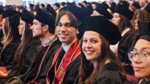 Graduates smiles at Commencement