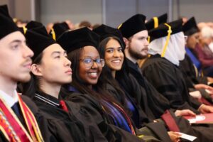 Graduates smile during ceremony