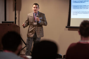 Landon Thompson presenting research in March 2024 at the Eastern New York Student Chapter of the American Society of Microbiology