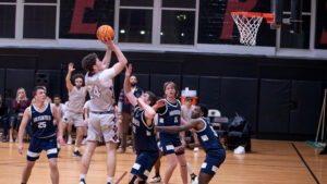 The ACPHS men's basketball team plays a game. A basketball player makes a hoop