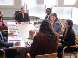 Mock Trial Team sits together in a round table discussion