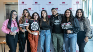 Parents and Families stand in front of ACPHS backdrop at Orientation