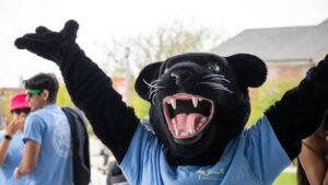 Paws the panther celebrates and holds hands up