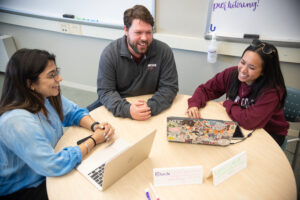 Two students attend mentor session with CSS assistant director
