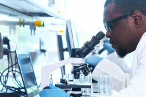 Scientist looking into microscope