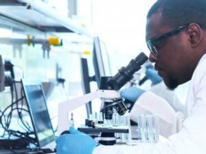 Scientist looking into microscope