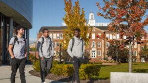 Students go for a walk on campus with fall foliage in background