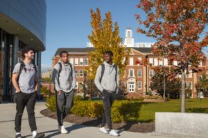 Students go for a walk on campus with fall foliage in background