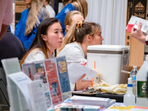 Students sit at table at health expo