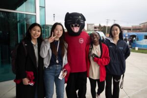 Students stand with Paws the panther