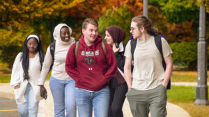 Students walk and laugh together on campus