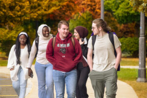 Students walk and laugh together on campus