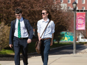 Students dressed up walk on campus on a sunny day