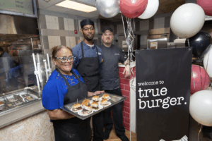 dining hall workers posing with snacks