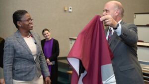 Vice President Michael Pasquarella unveils the plaque to President Tofade
