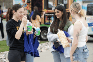 four students enjoying treats during welcome week 