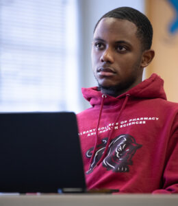 A student takes notes on laptop during class