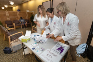 Student prepare materials on table for Narcan training