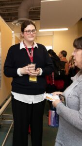 Bridget Longden discusses research poster with faculty member