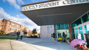 Students walk outside Gozzo Student Center on a suny fall day