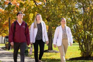 Students walking on ACPHS campus to class on a sunny Fall day