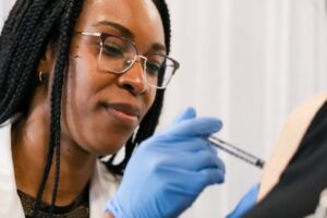 Female nurse or PA giving vaccine to patient