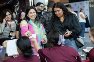 At prospective student checks in at table at ASD event