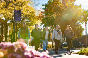 Students walking on campus in the fall