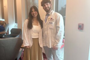 Two ACPHS students at a reception in the Panther's Den following the Rho Chi/PLS Induction.
