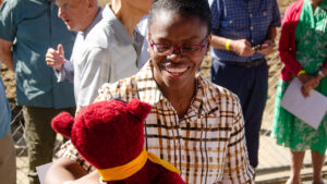 ACPHS President Toyin Tofade receives a red Panther from a campus member