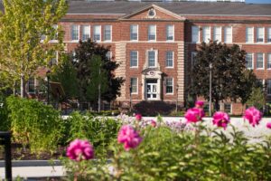 Summer campus view of the Library with pink flowers